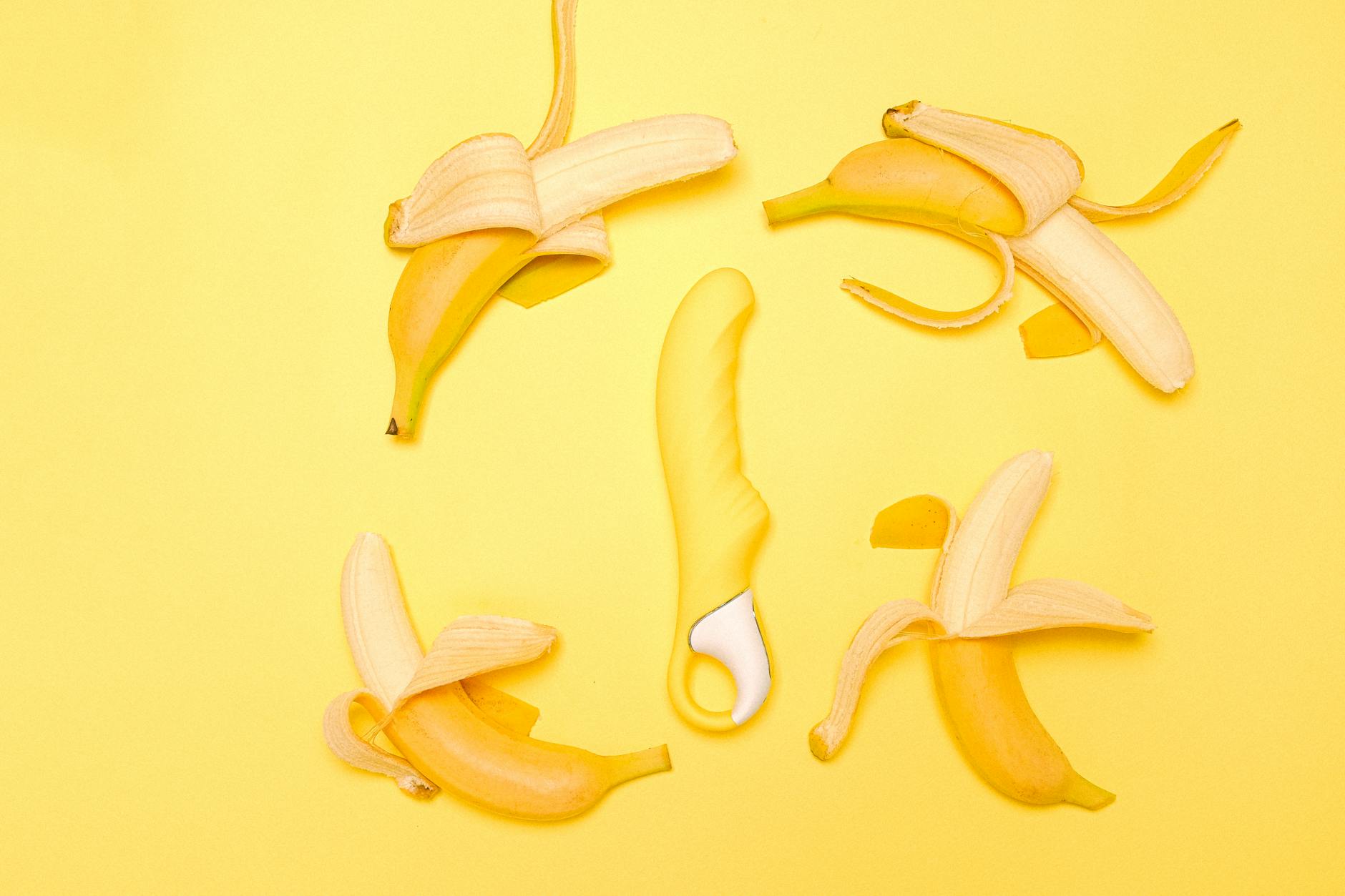 A bright yellow lemon vibrator on a soft surface, symbolizing pleasure and safety during pregnancy