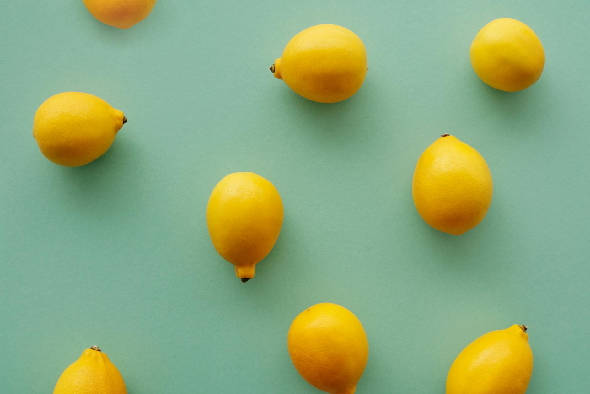 Bright yellow lemons arranged on a pastel background, symbolizing the fresh approach to sexual wellness with lemon vibrators