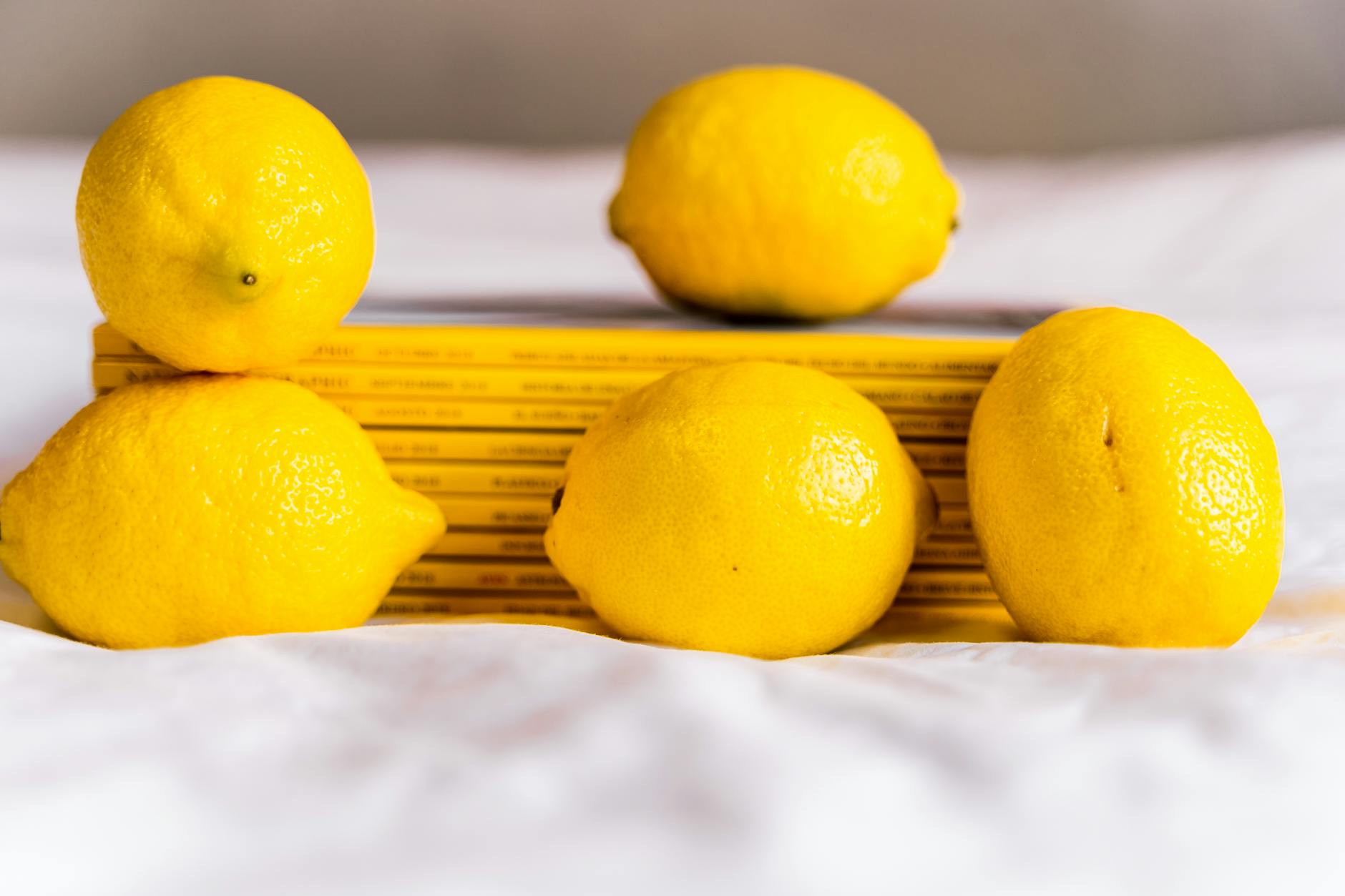 Fresh lemons arranged with books, symbolizing the interplay between body science and pleasure